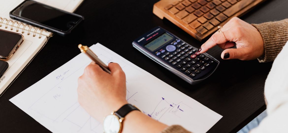 A person entering financial data into a computer system, showcasing meticulous data entry and record-keeping services for accurate financial tracking.